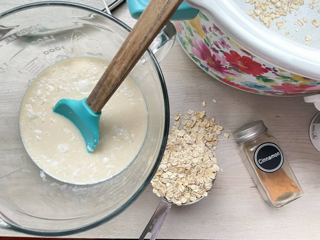 mixing up baked oatmeal in a large glass measuring bowl