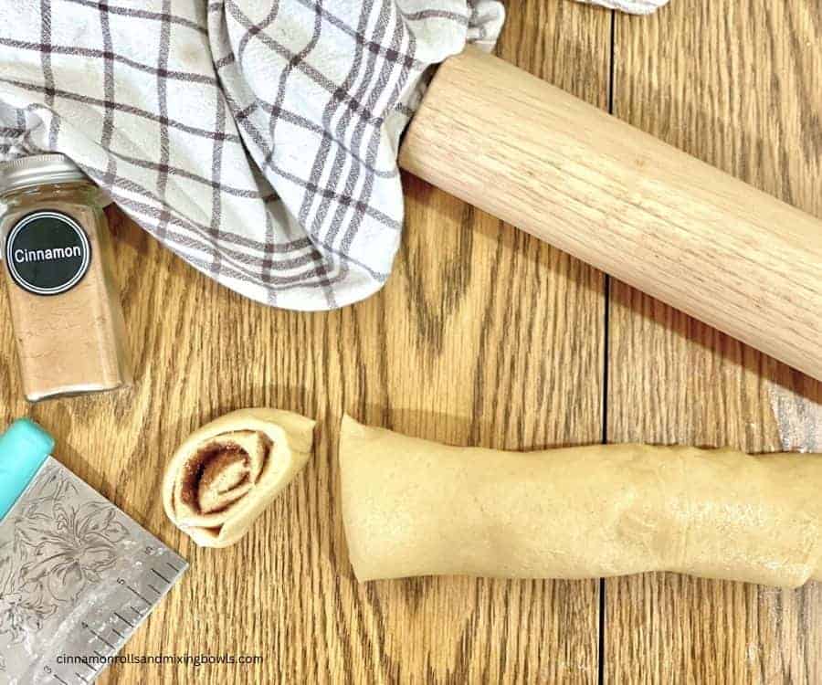 slicing roll of kamut cinnamon rolls dough