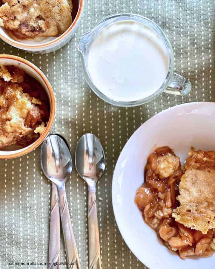 apple cobbler in the crockpot with sourdough topping  set in dishes