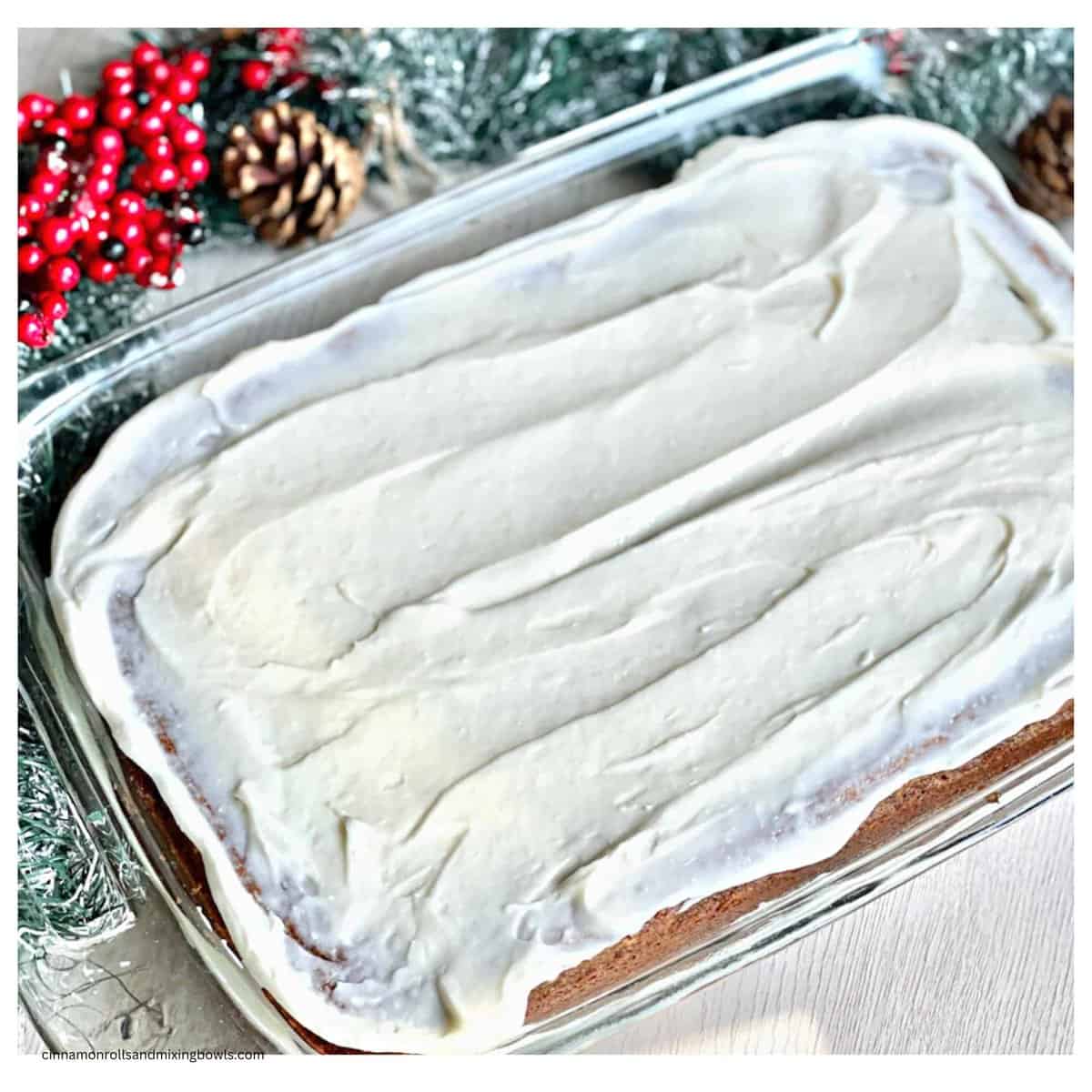 Eggless Holiday spice cake in pan with frosting