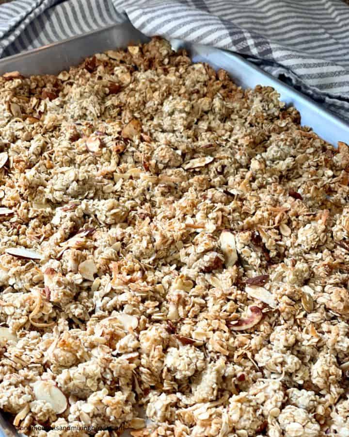 homemade crunchy coconut almond granola cooling in pan