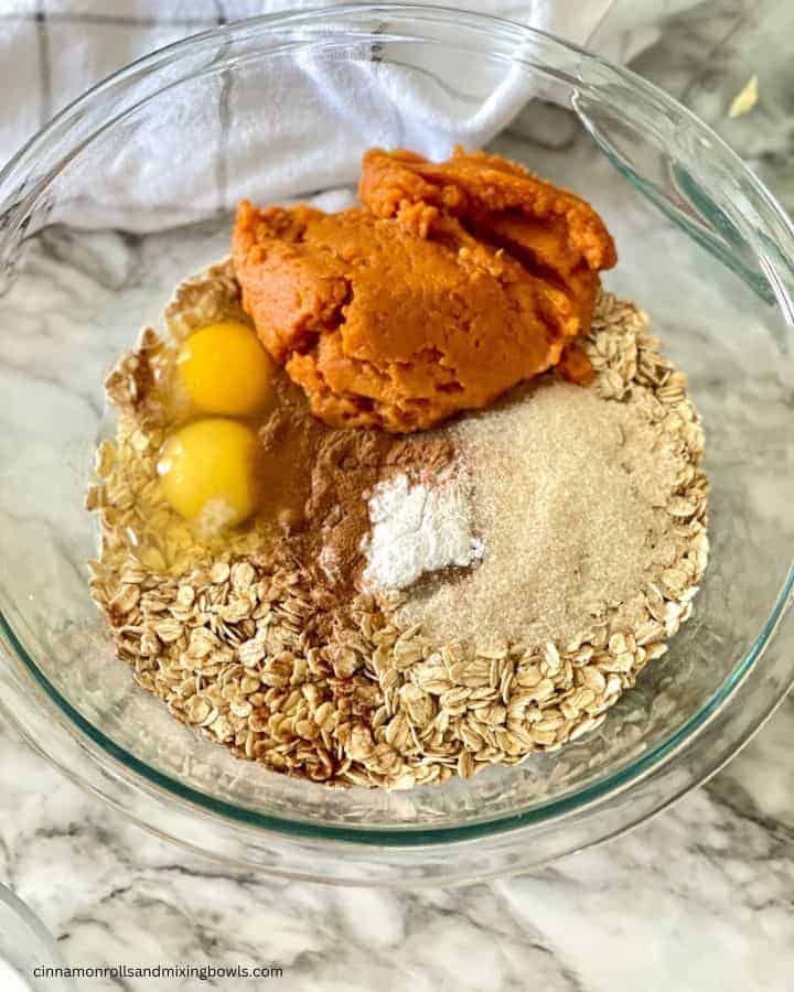 ingredients in bowl for pumpkin baked oatmeal