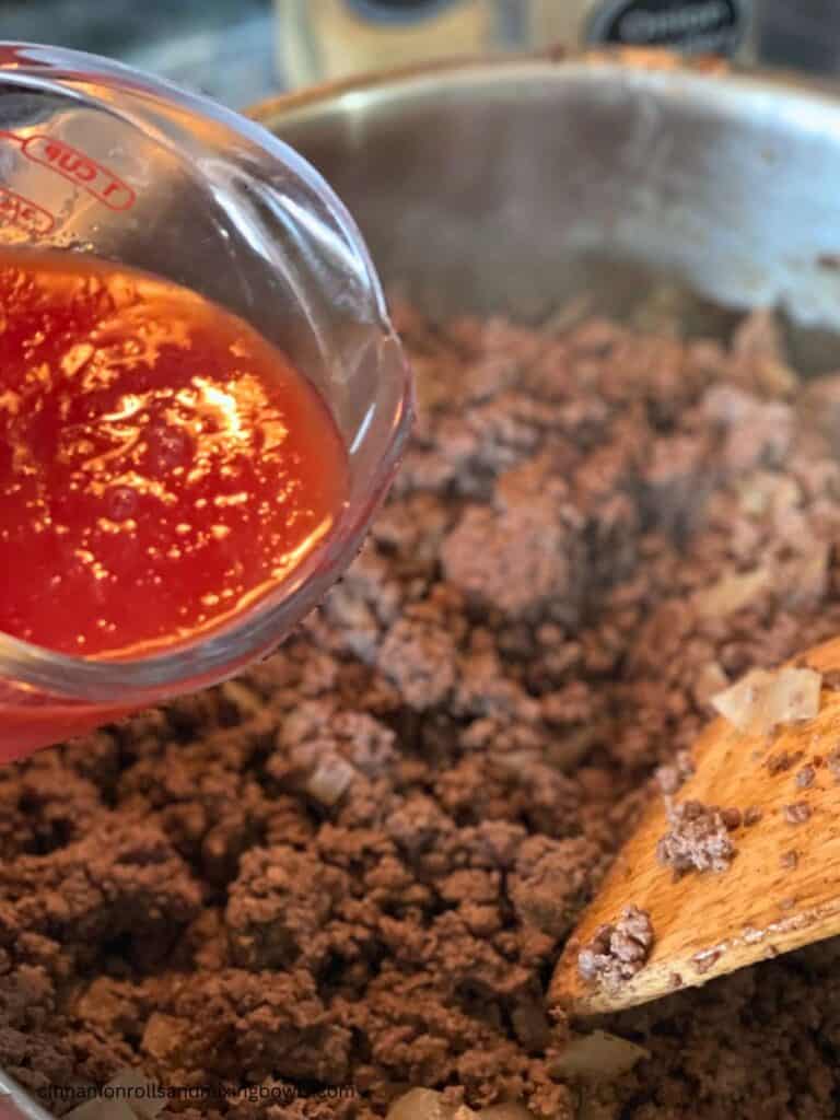 Tomato sauce being added to healthy sloppy Joes