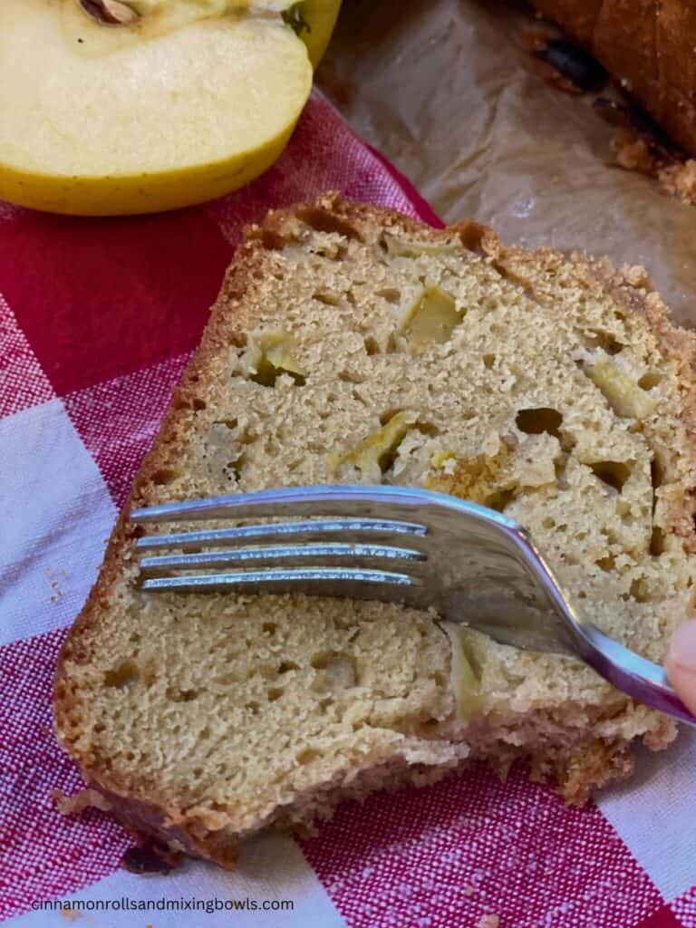 Sourdough Dutch apple bread sliced on red plaid cloth 