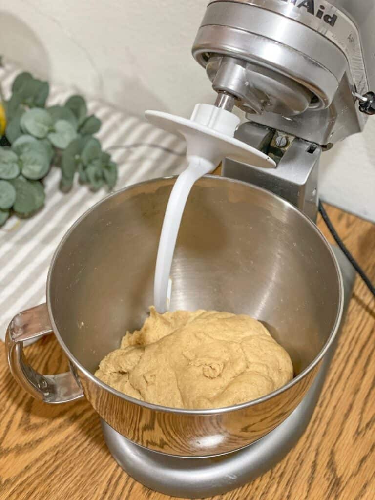 kamut pizza crust in mixer on table with dough rising in mixer bowl