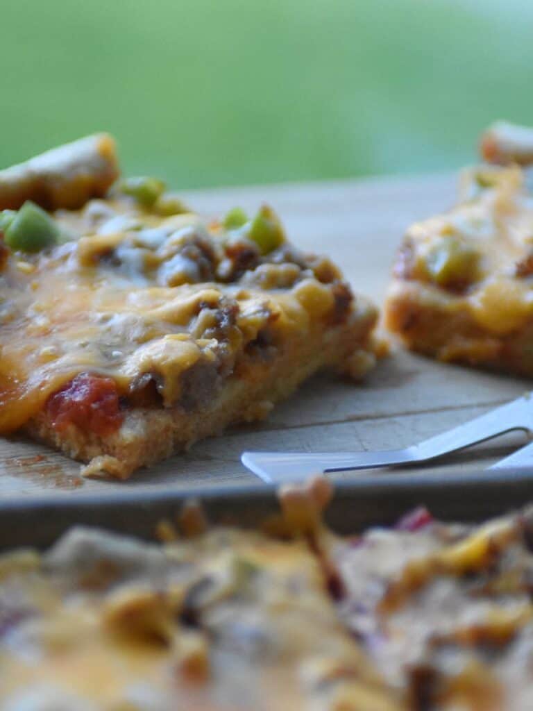 Freshly milled kamut pizza crust in pan by window