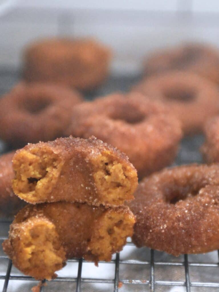 a freshly milled kamut pumpkin donut in half, facing the camera